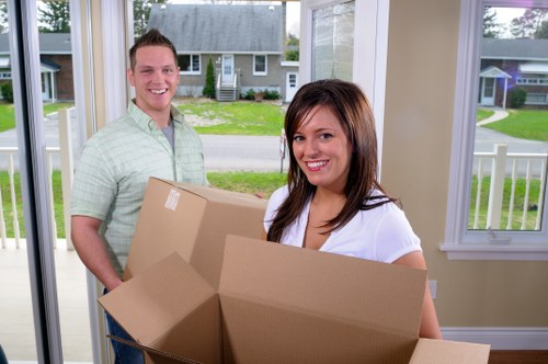 Local packing team preparing fragile household items in Southall