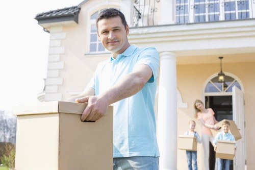 A professional house removals team handling furniture carefully during a Southall move