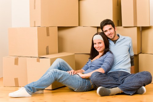 Removalists loading household furniture into a van for a local move